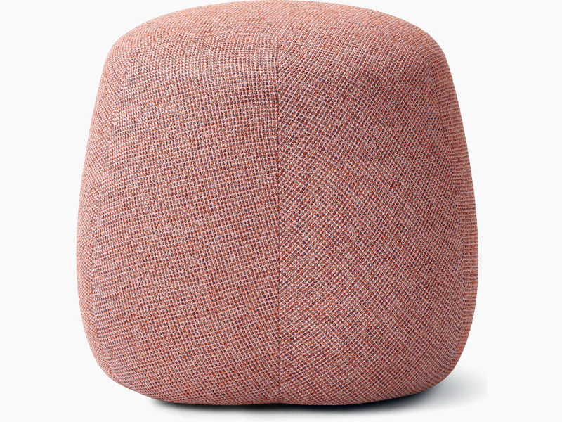 White background shot of a Truffle Pouf, Size B, fully upholstered in pink fabric.
