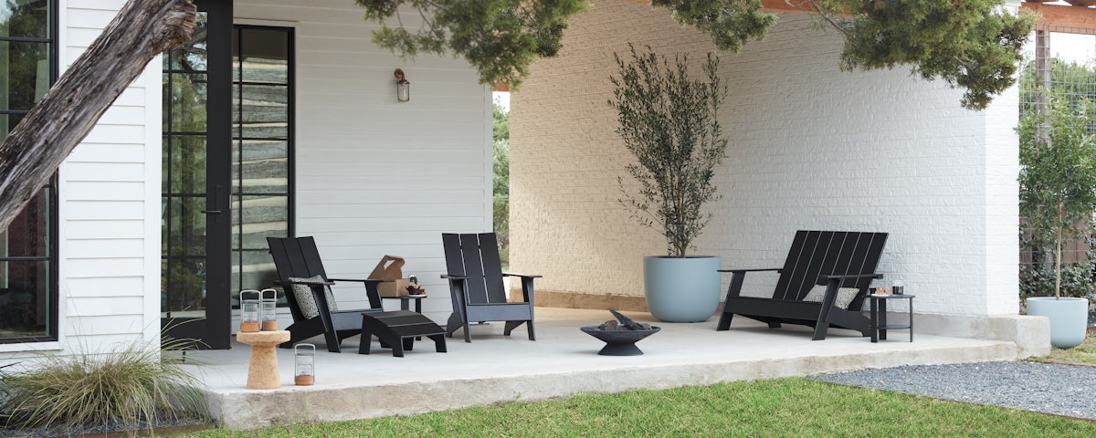 Adirondack Two Seater Bench, Chairs, Ottoman and Lollygagger Side Table in outdoor patio setting