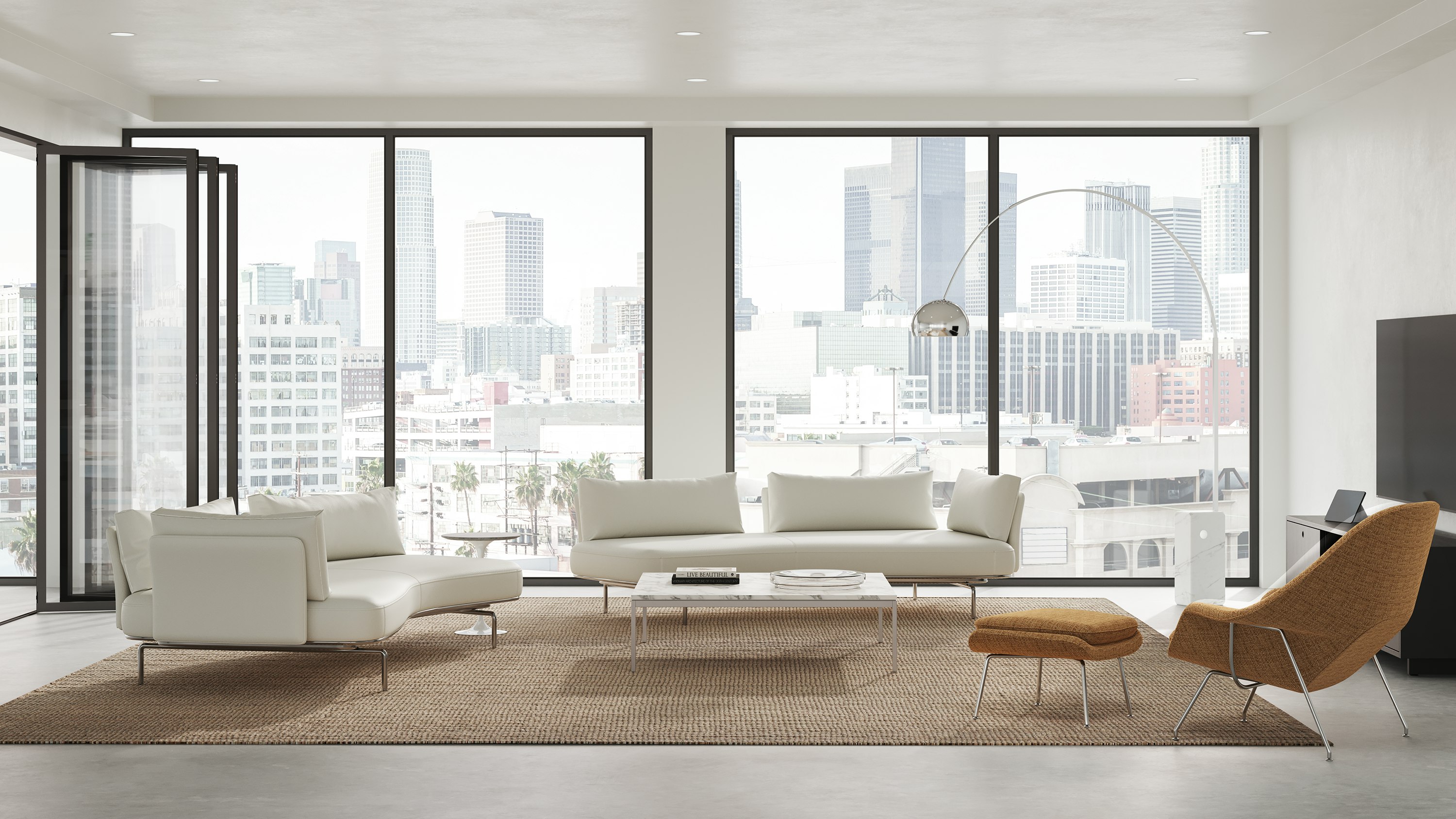 A private home with a living setting consisting of two Panoramic sofas, right and left side, Womb chair with ottoman and F.Knoll Coffee table.