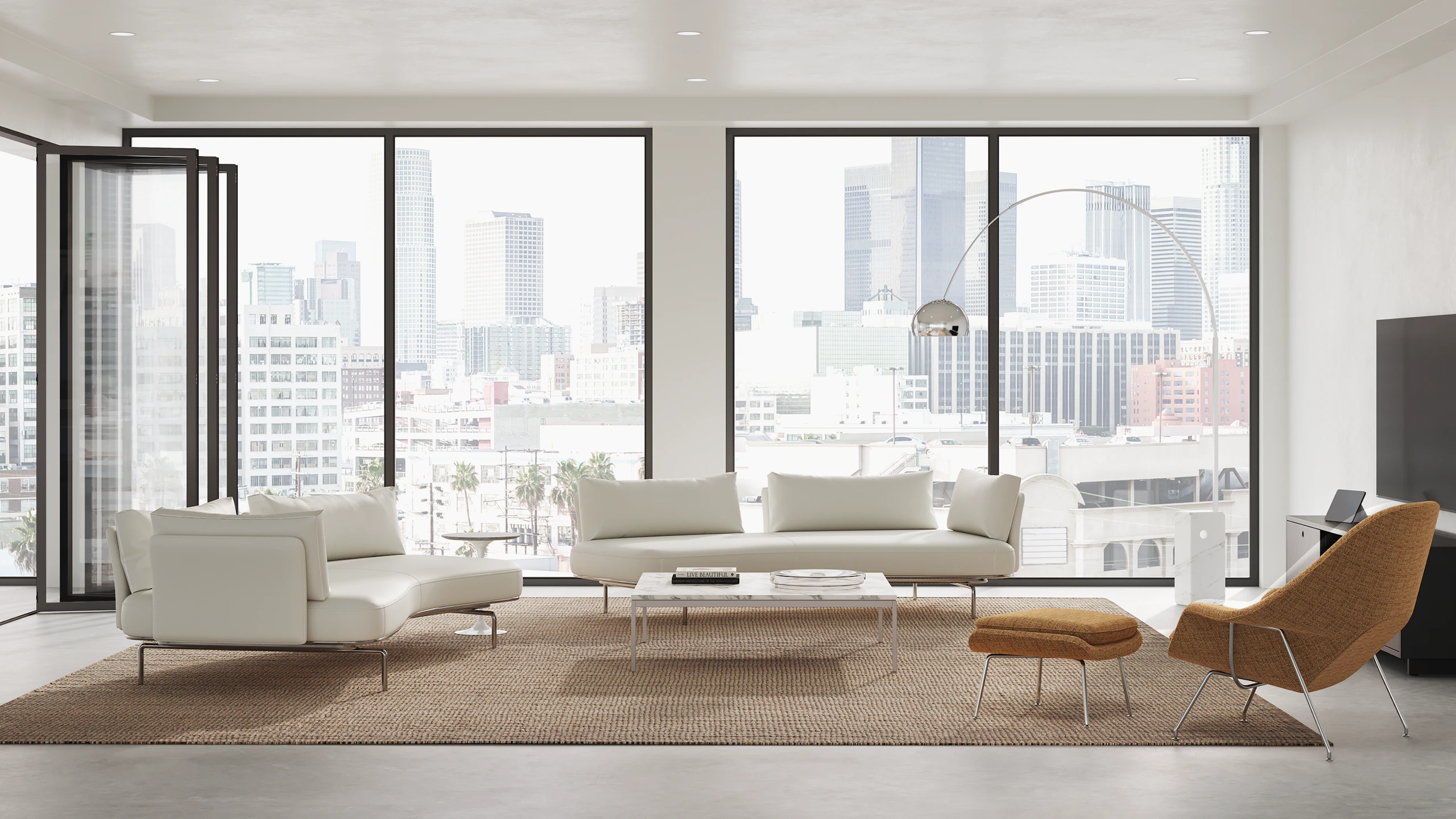 A private home with a living setting consisting of two Panoramic sofas, right and left side, Womb chair with ottoman and F.Knoll Coffee table.