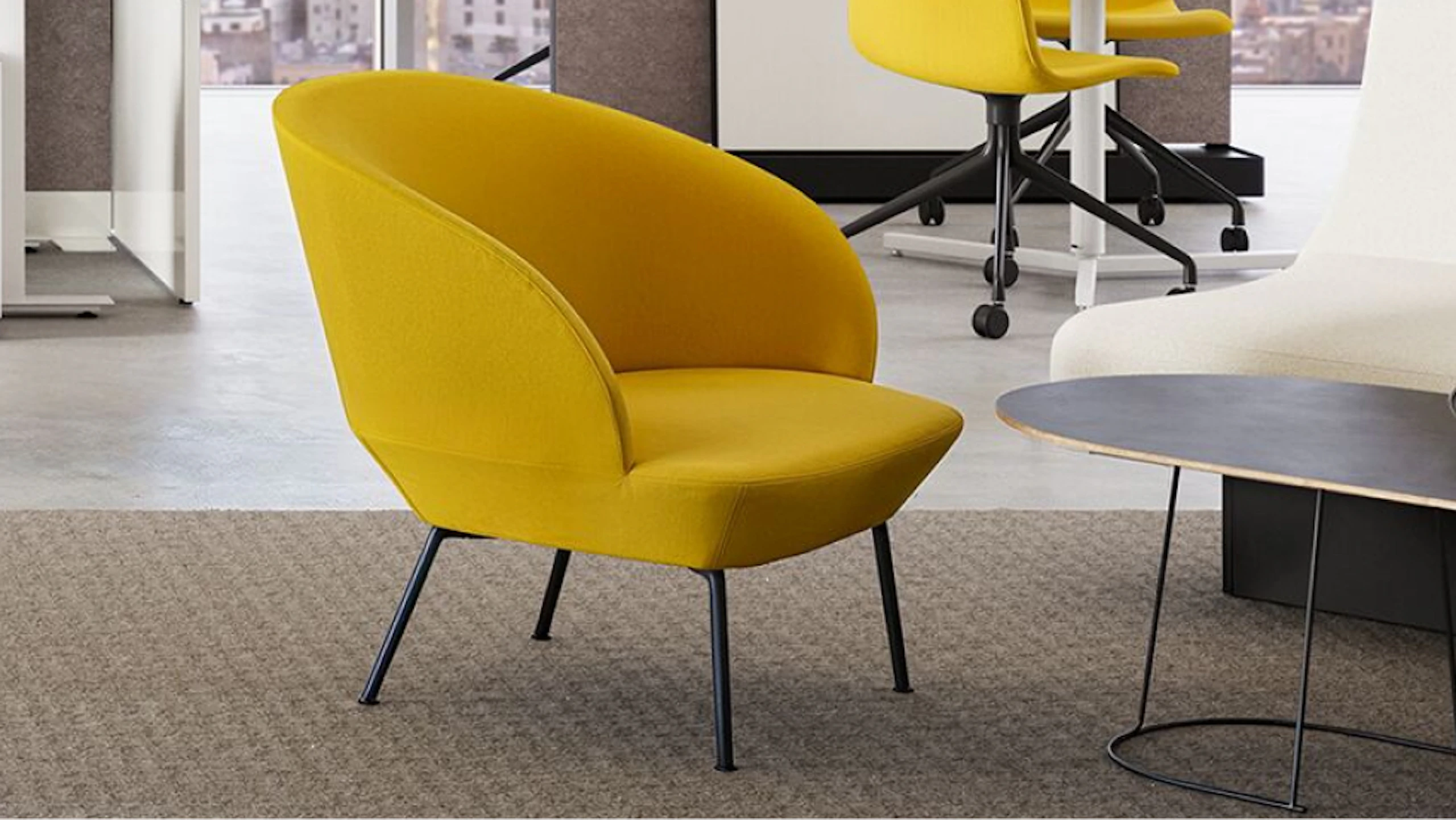 A yellow Muuto Oslo Lounge Chair and white NaughtOne Rhyme Seating System in a team neighbourhood setting designed to facilitate connection and collaboration