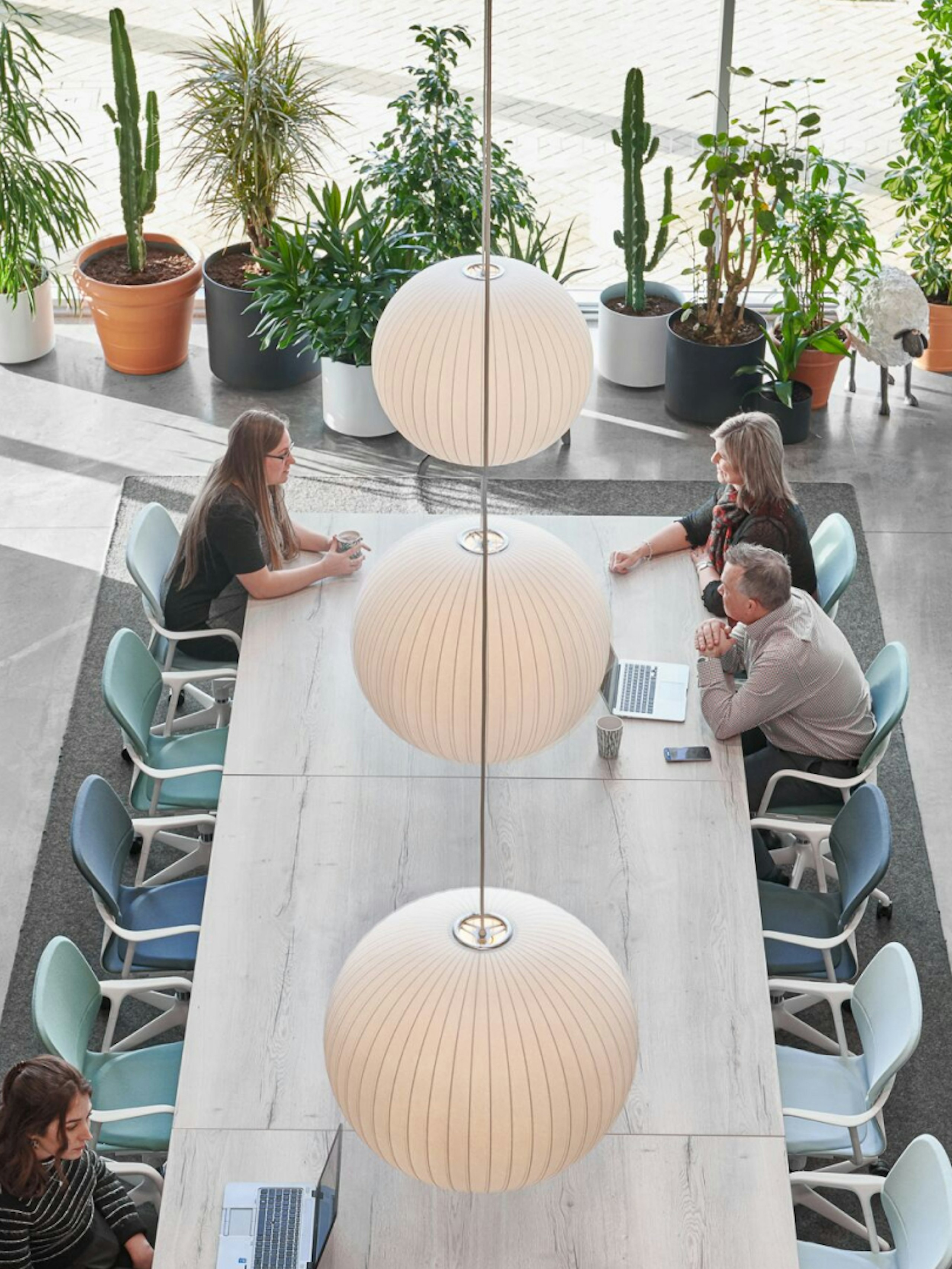 People working at a Layout Studio table with Keyn Chairs.