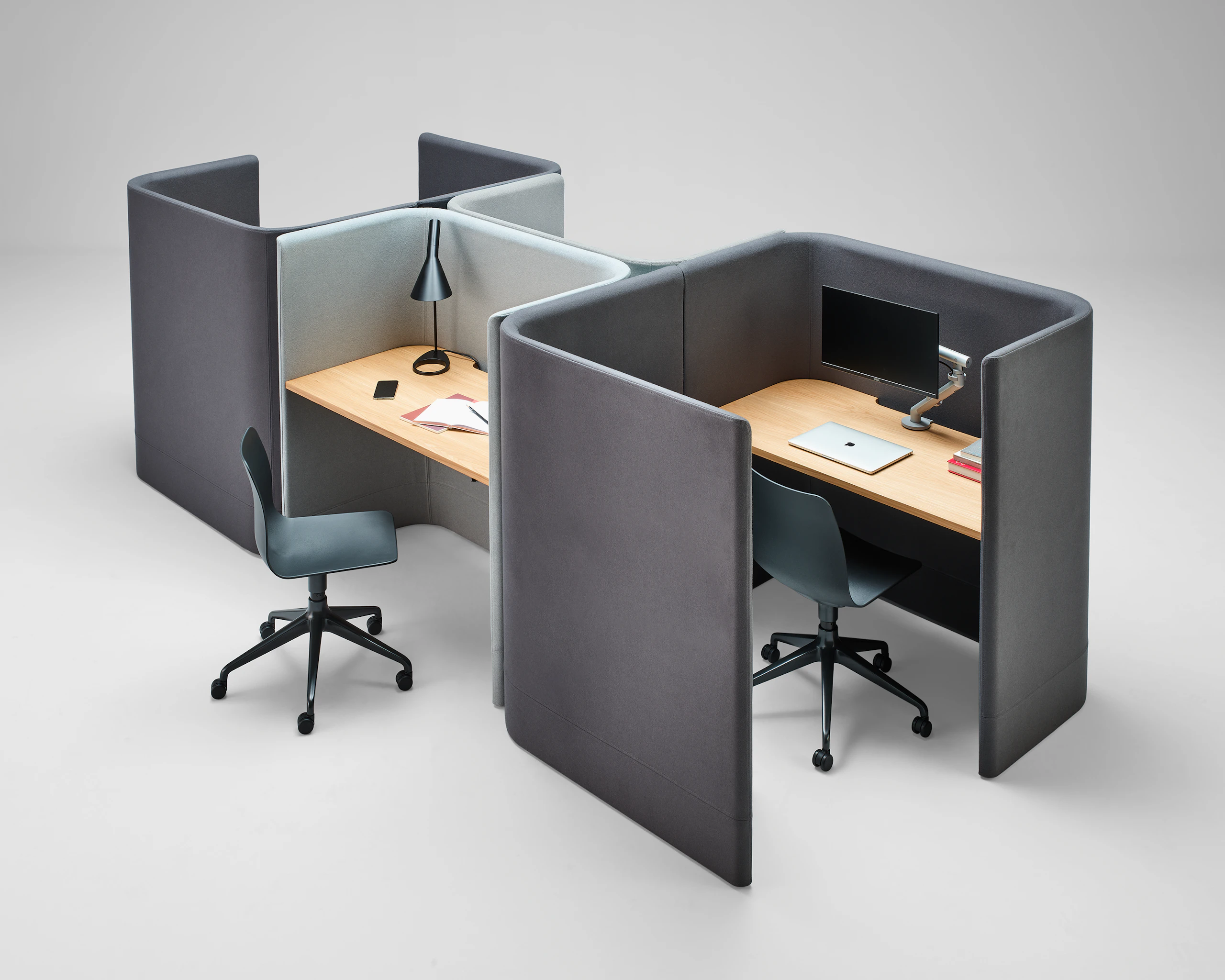 A three quarter angle of two Pullman Desk Pods with a Pullman Desk, upholstered in grey fabric, with oak desk tops.