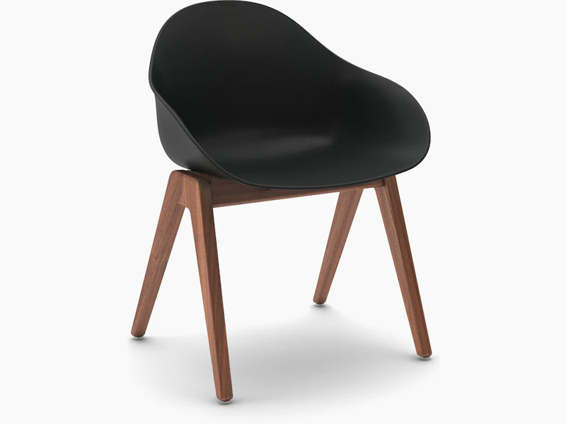 Three-quarter view of a black Ruby Wood Chair with walnut legs.