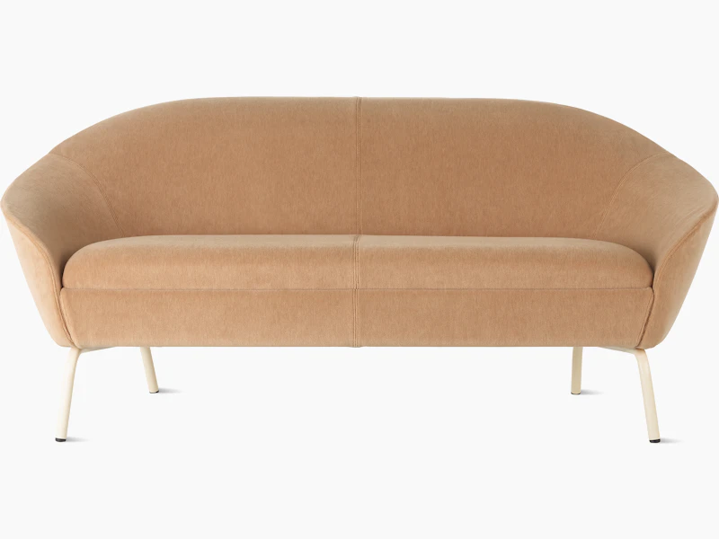 White sweep shot of peach upholstered Ever 2 seat sofa on oyster steel legs.