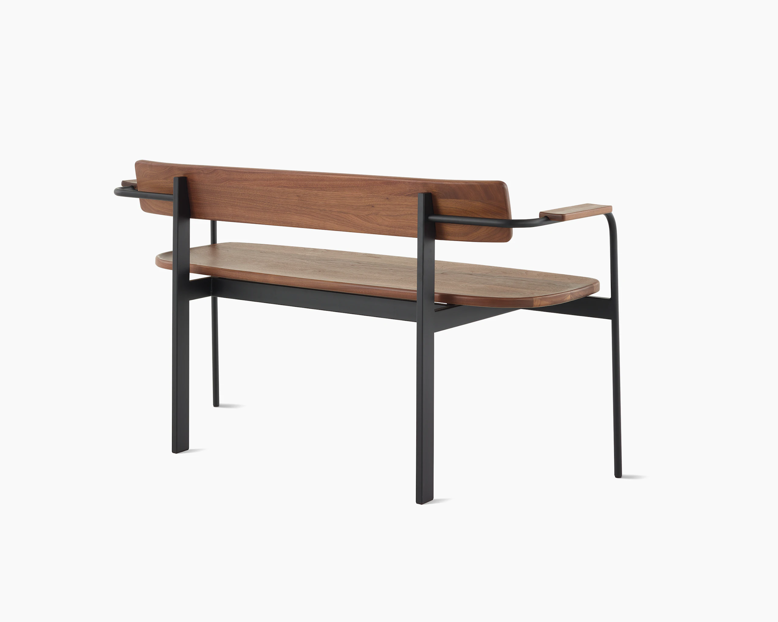 A Betwixt Bench with walnut seat, backrest, and arms with a black frame.