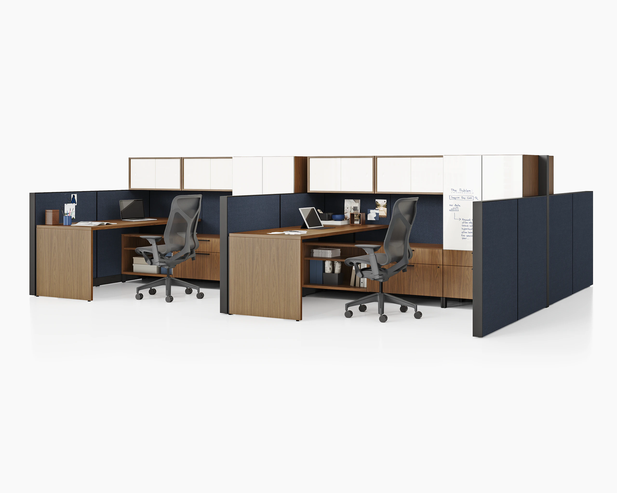 Two Canvas Wall workstations with dark wood surfaces, blue panels, white overhead storage, and black Cosm chairs.