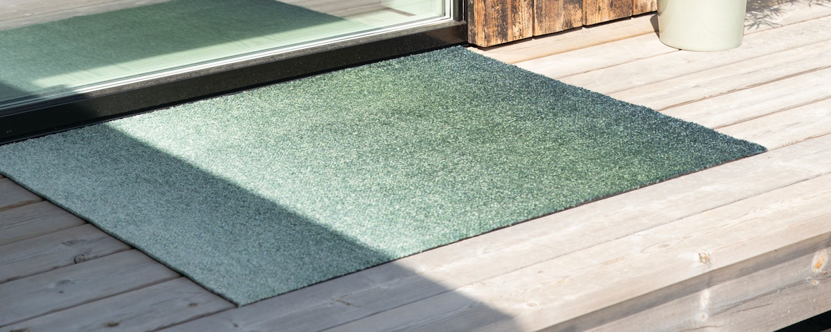 Heymat Dis Mat on an outdoor deck door threshold