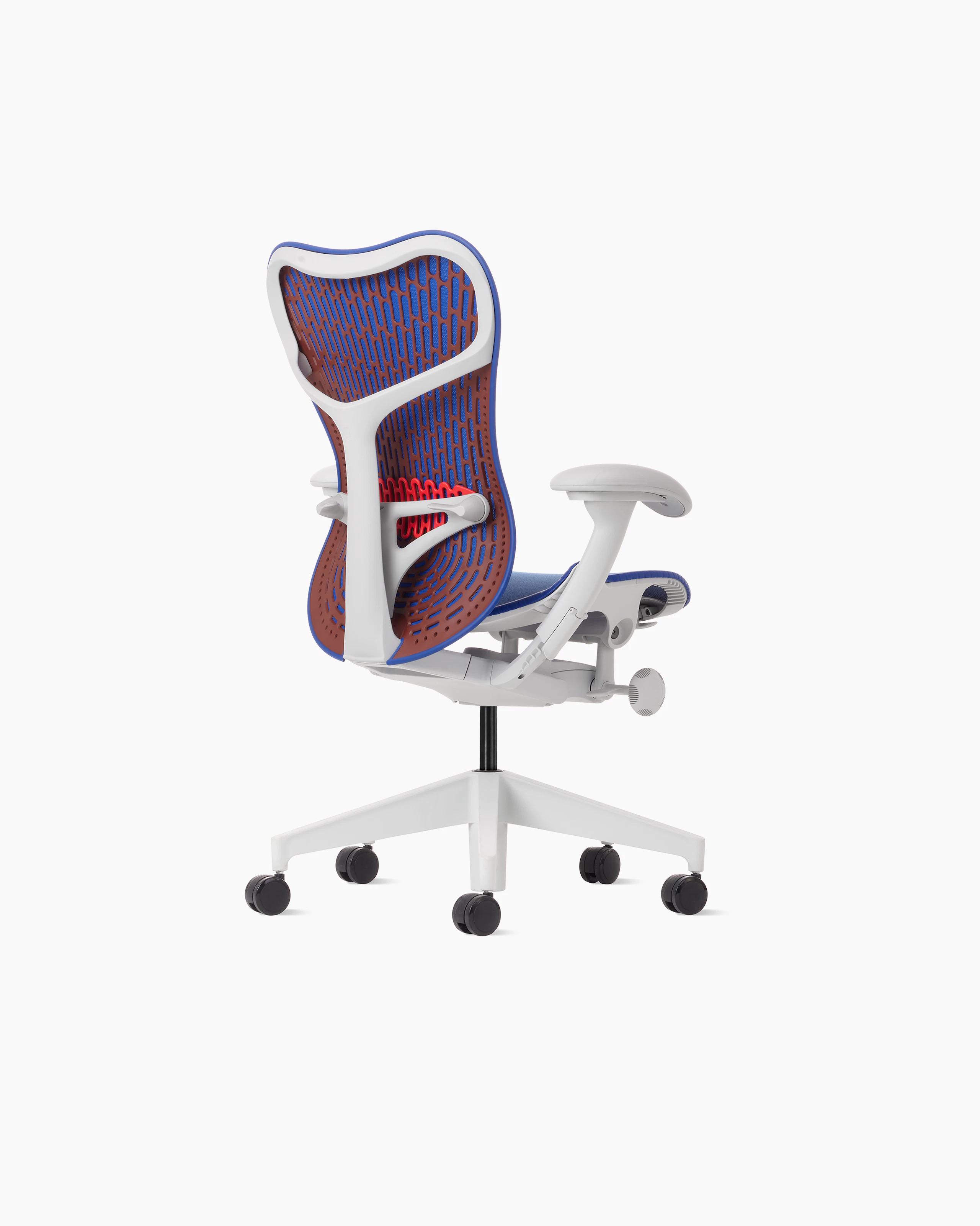 Rear angle view of a Mirra 2 chair with a Butterfly back in ultramarine color-block and alpine frame.