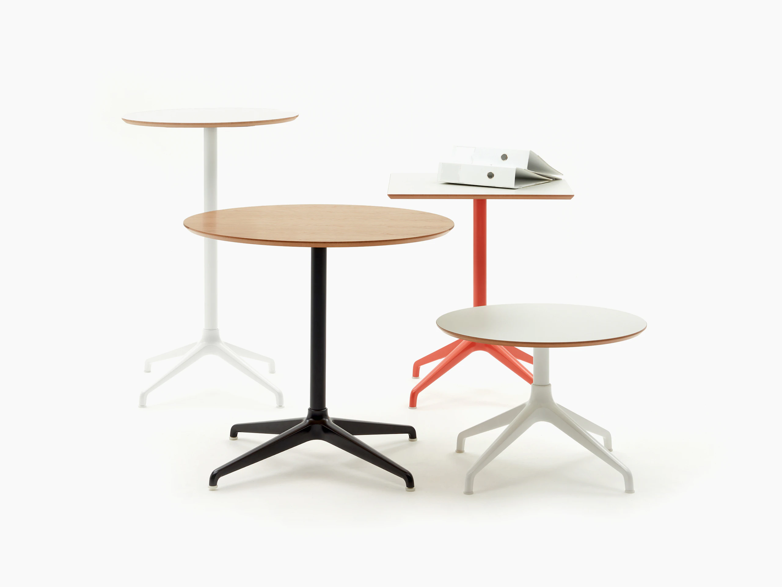 Group shot of four differently sized Ali Tables, all with a 4 star base in a variety of colours.
