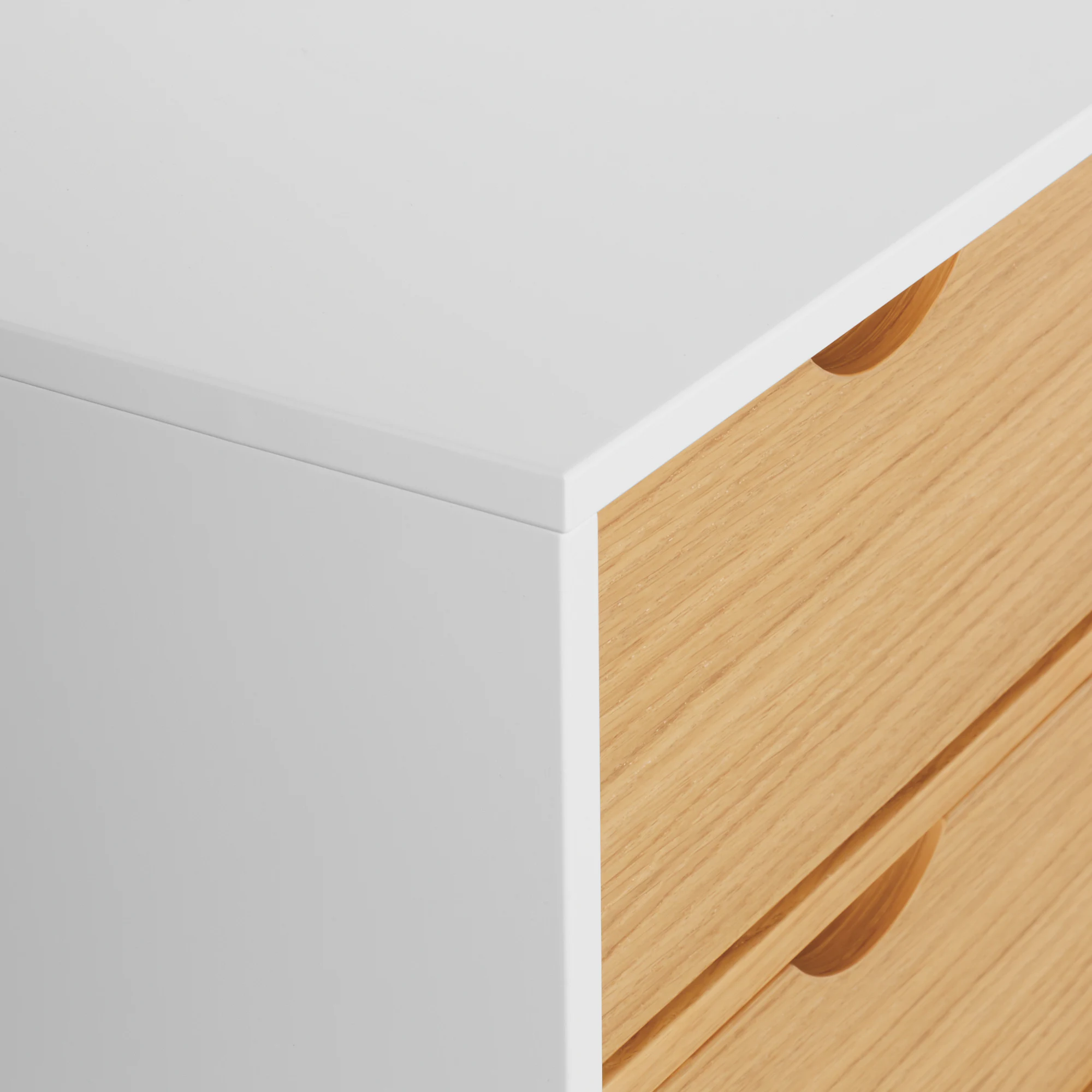 Close-up of Aura credenza edge with white frame and oak wood panel