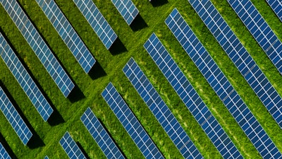 An image of solar panels in a green field.