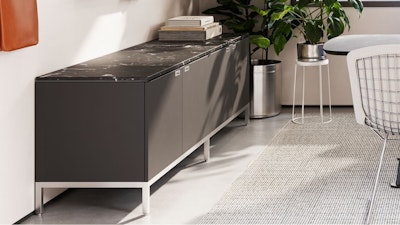 A group conference room setting - furnished with a black, grey, and white Knoll Florence Knoll Credenza, white Knoll Bertoia chair, and green potted plants - designed to facilitate change and reduce disruption in the space.