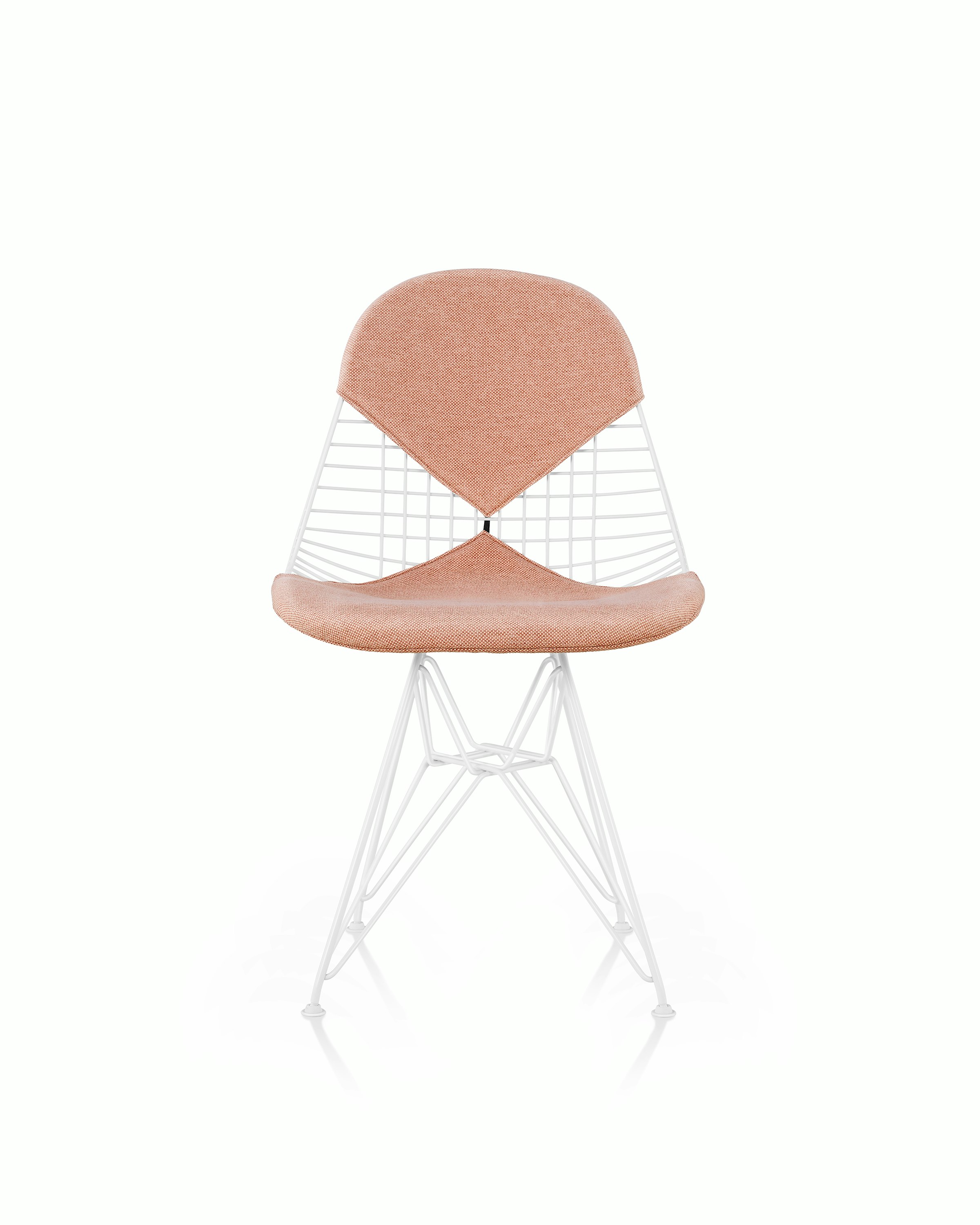 An Eames Wire Chair with a bikini seat and back, upholstered in a light pink textile. Viewed from the front.