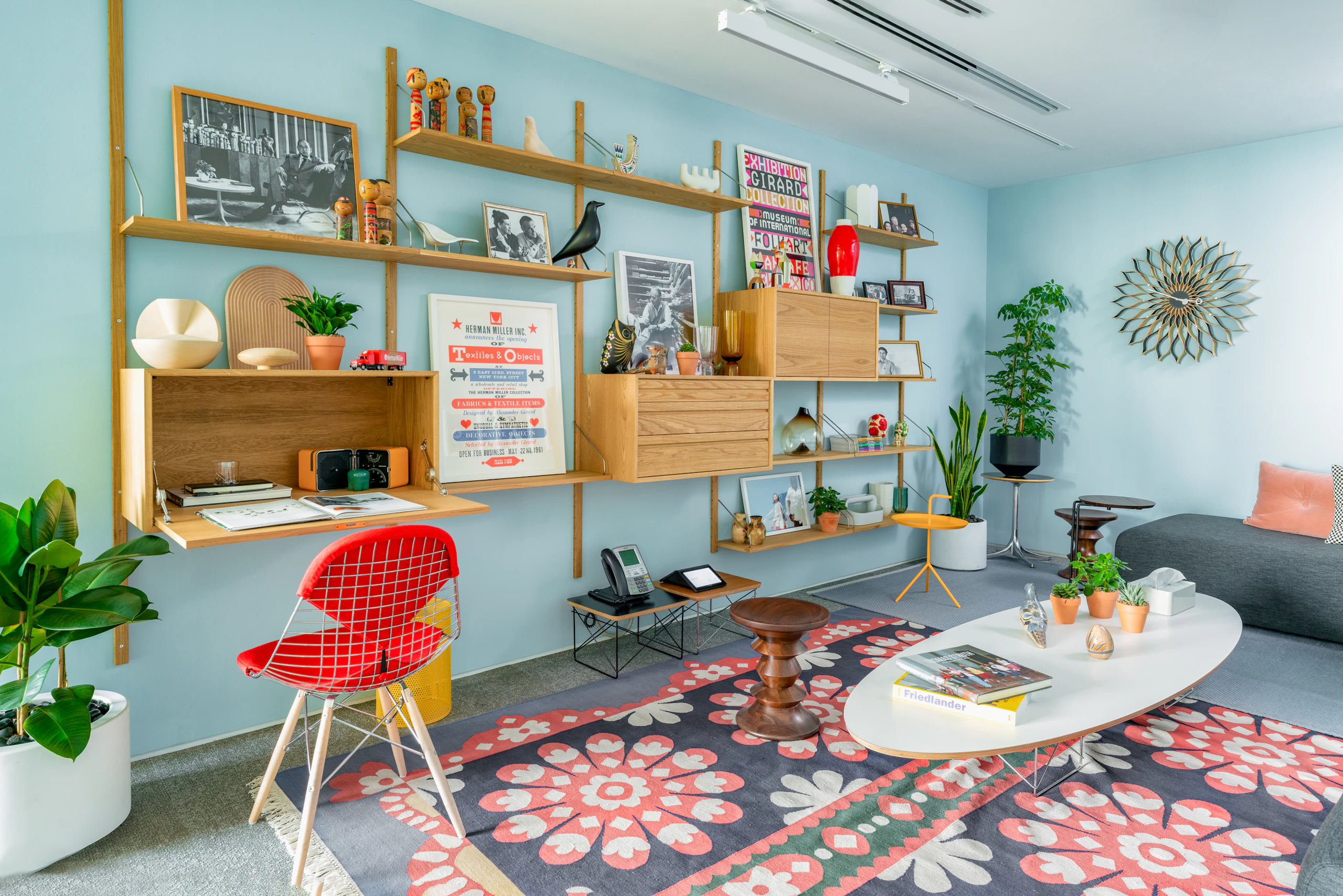 Royal System Shelving with HAY Mags Sofa, and a collection of side and coffee tables on a Maharam Mandala Rug.