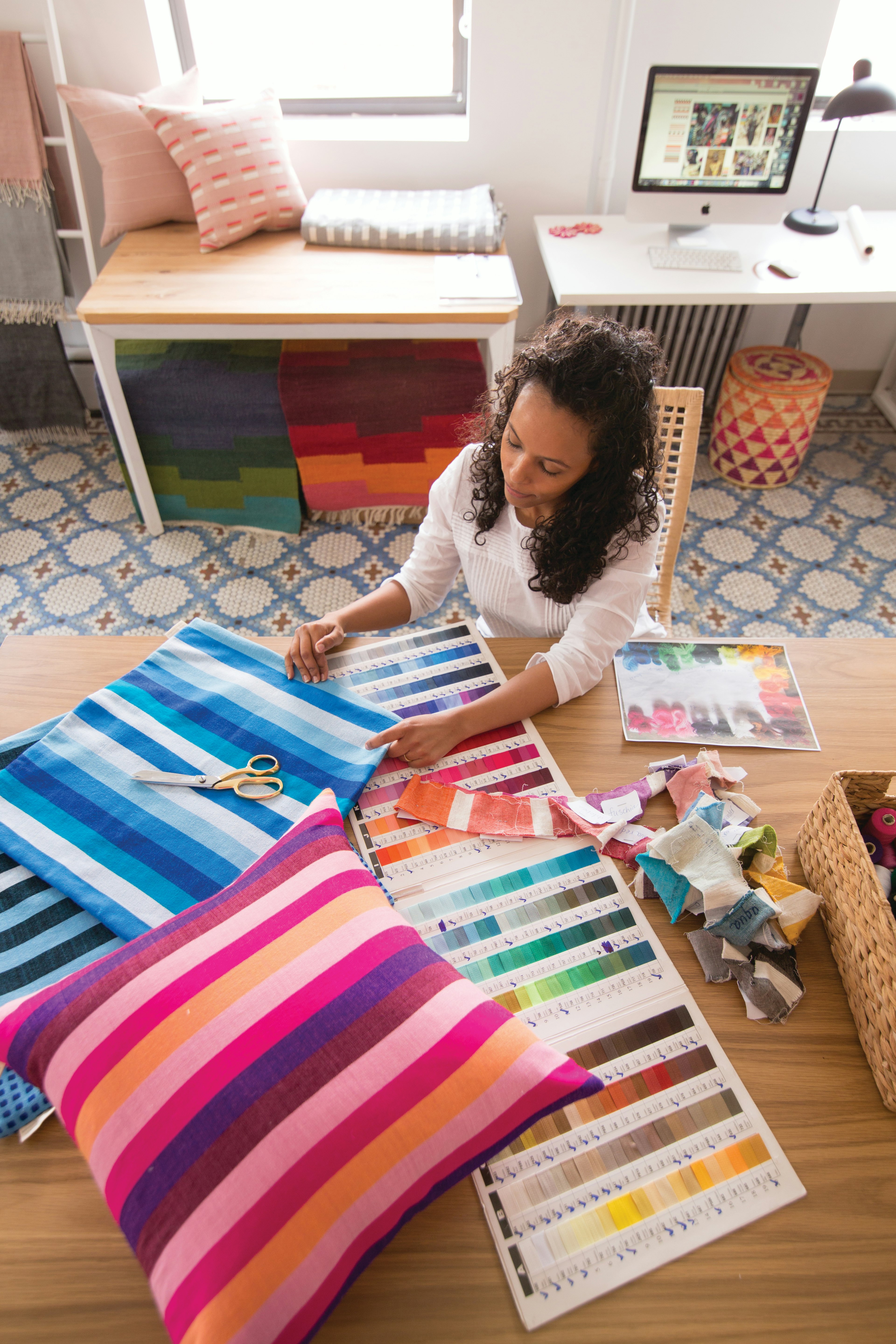 Hana Getachew reviewing textile and swatch samples