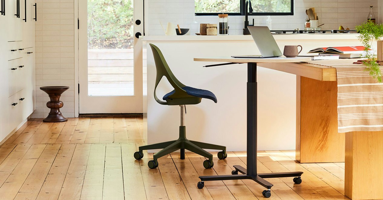 An olive colored Zeph Chair with a large Passport Work Table in a home kitchen setting.