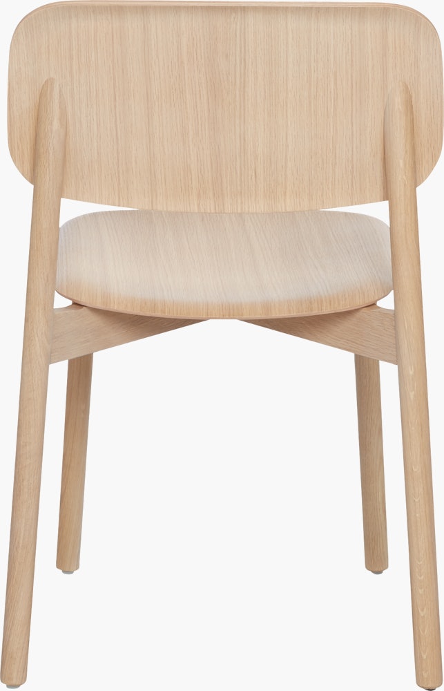 A matte lacquered oak Soft Edge 12 Side Chair viewed from the back