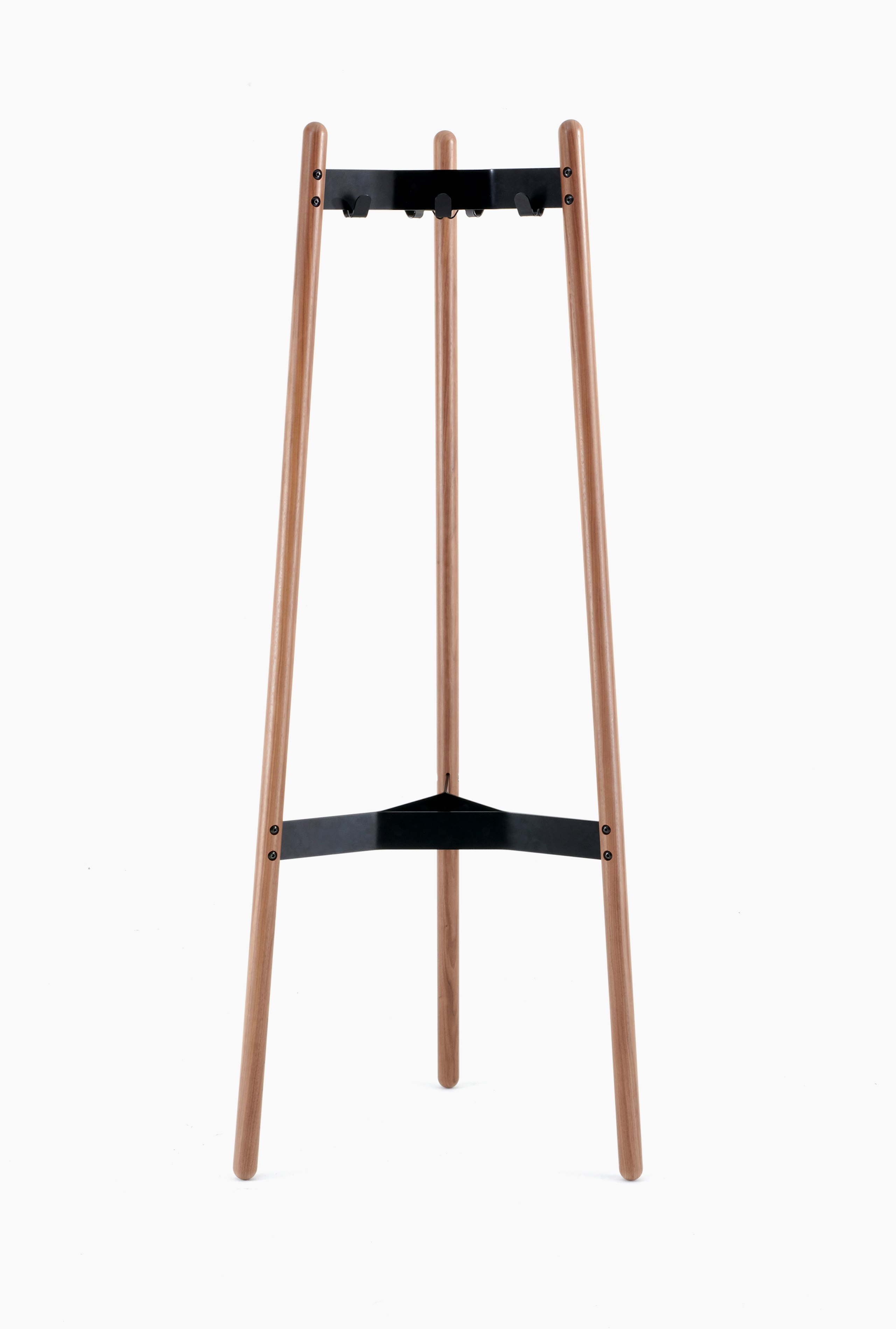 A front view of a Hudson Coat Stand with walnut dowel legs and black metal supports.