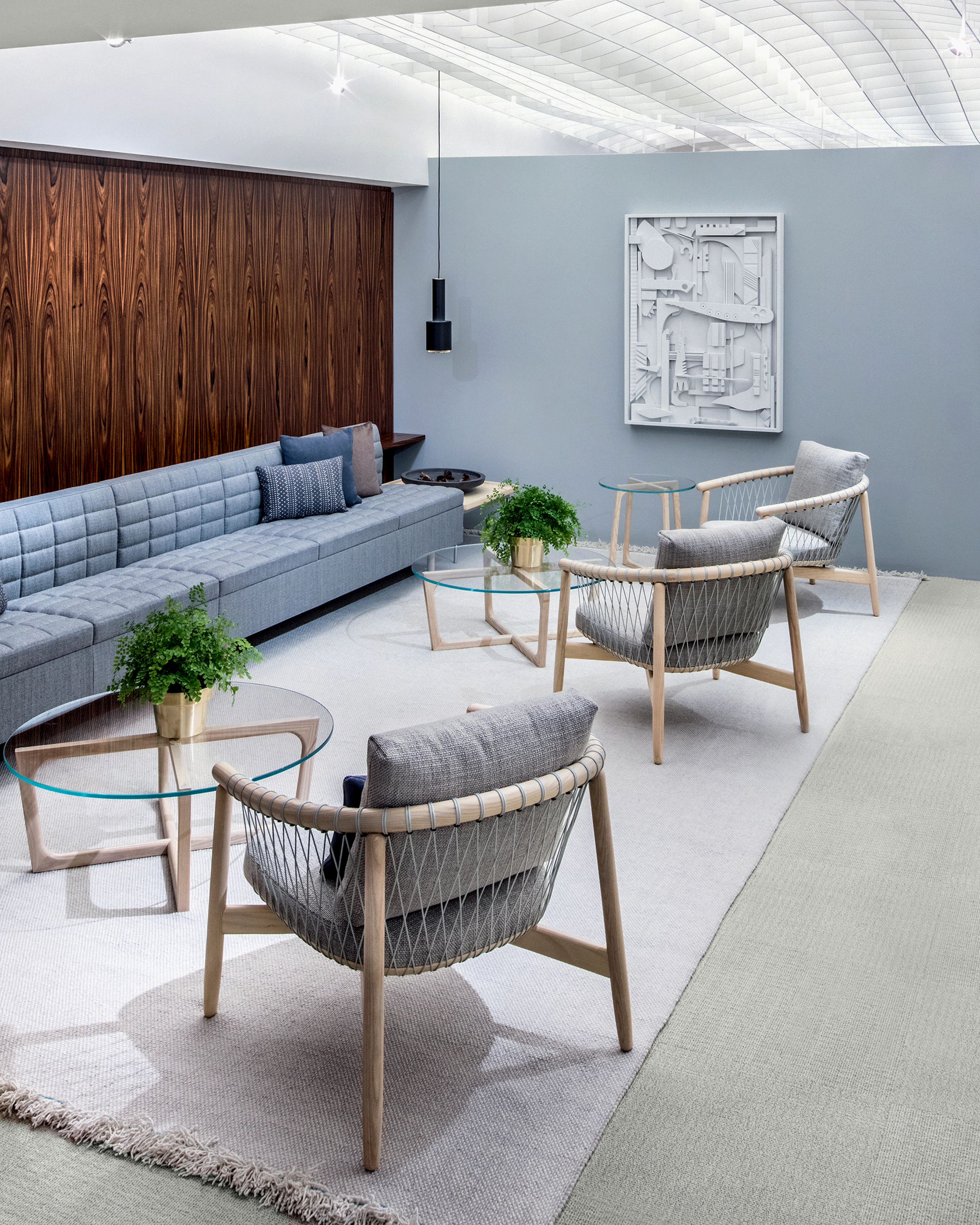 A casual meeting space featuring light gray Crosshatch lounge chairs and light blue Tuxedo Classic Lounge Seating.