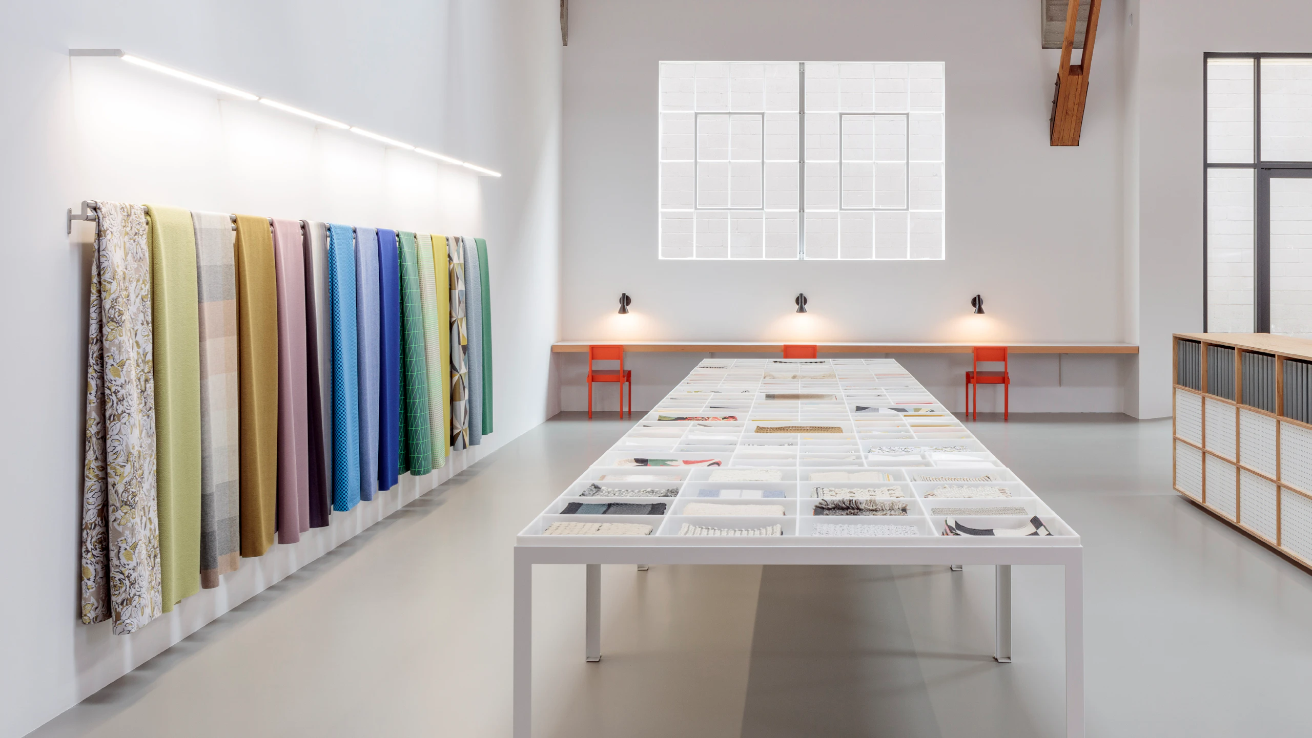 An interior image of a Maharam showroom showcasing a variety of colorful textiles.