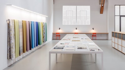 An interior image of a Maharam showroom showcasing a variety of colorful textiles.