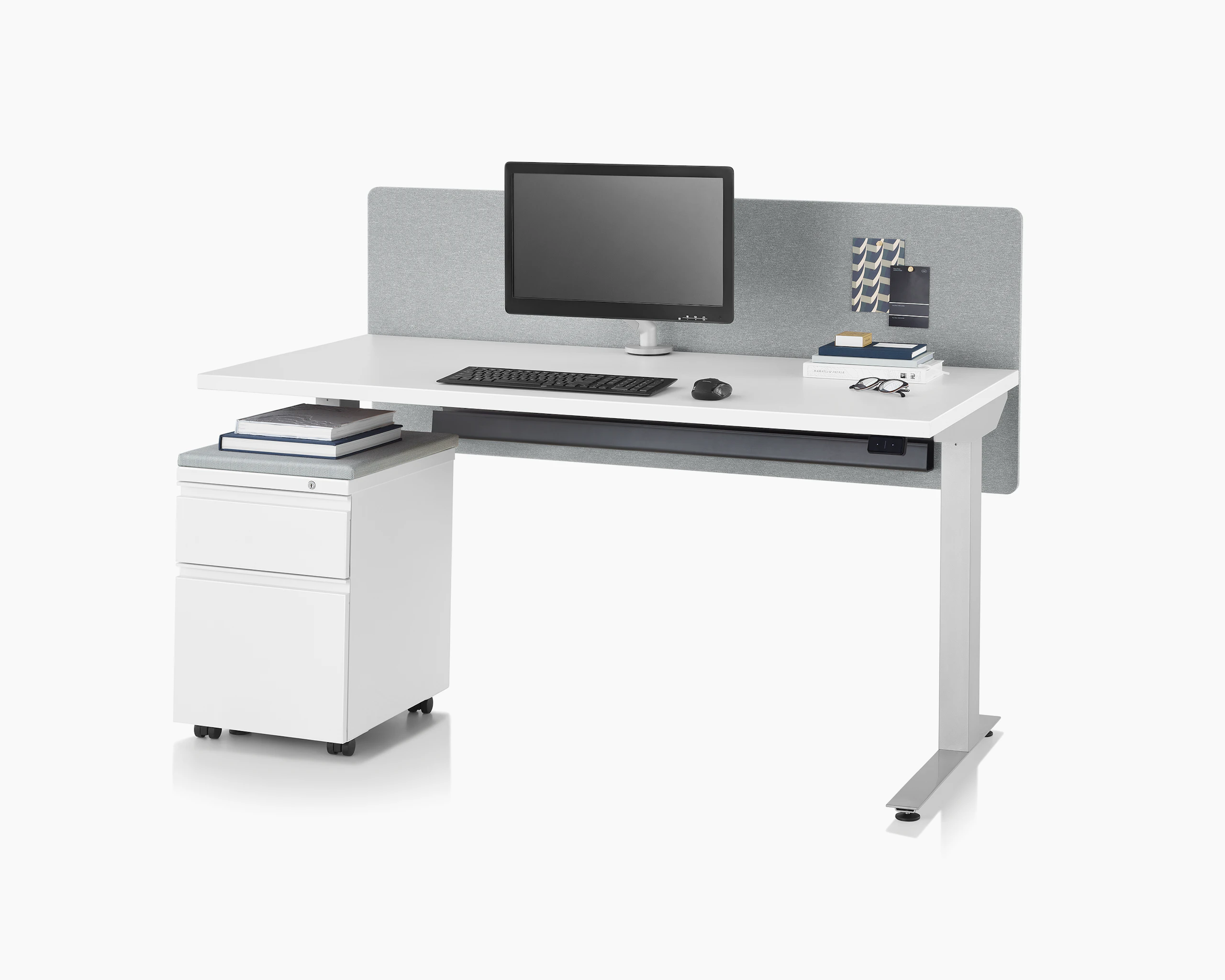Nevi Sit-to-Stand Table with a white top, silver legs, gray fabric surface-attached screen, Flo monitor arm and a mobile Tu Storage unit.