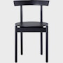 A black Comma Chair, viewed from the front.