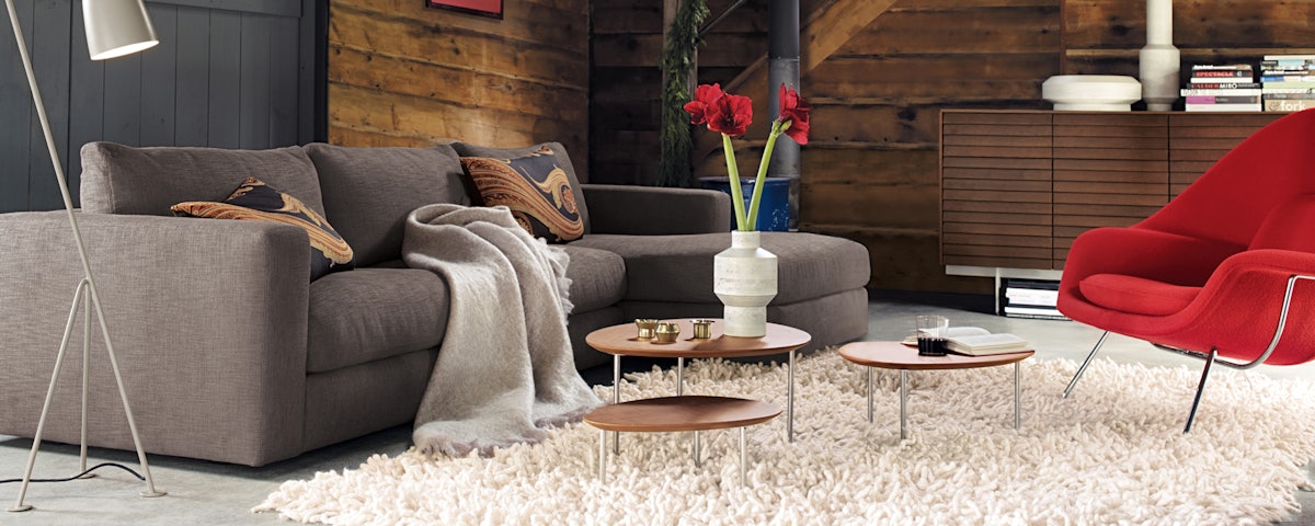 Eclipse Nesting Tables, Womb Chair, and Grasshopper Floor Lamp in a living room setting 