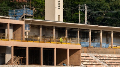 An exterior construction scene showing the renovation process of the Pacaembu Sports Complex by RADDAR