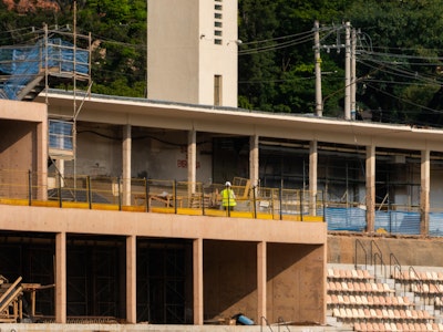An exterior construction scene showing the renovation process of the Pacaembu Sports Complex by RADDAR