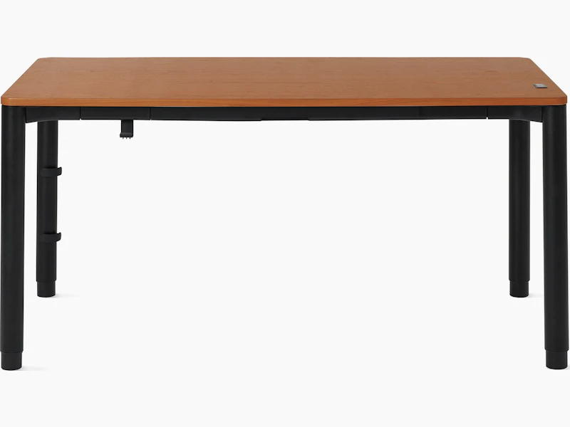 Four leg height-adjustable table with a woodgrain surface and black legs.