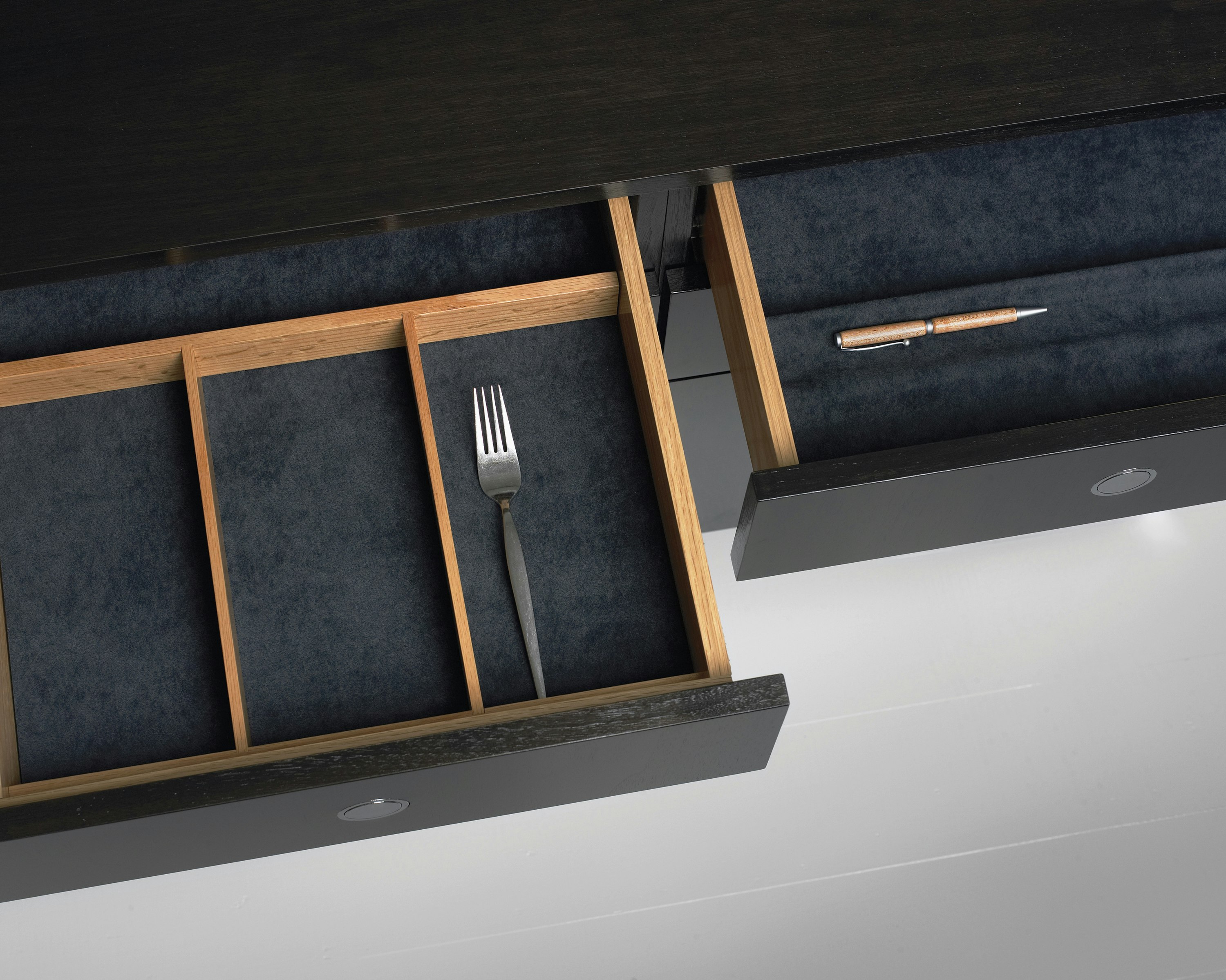 Overhead view of two open drawers in an H Frame Storage credenza, showing optional inserts for organizing supplies.