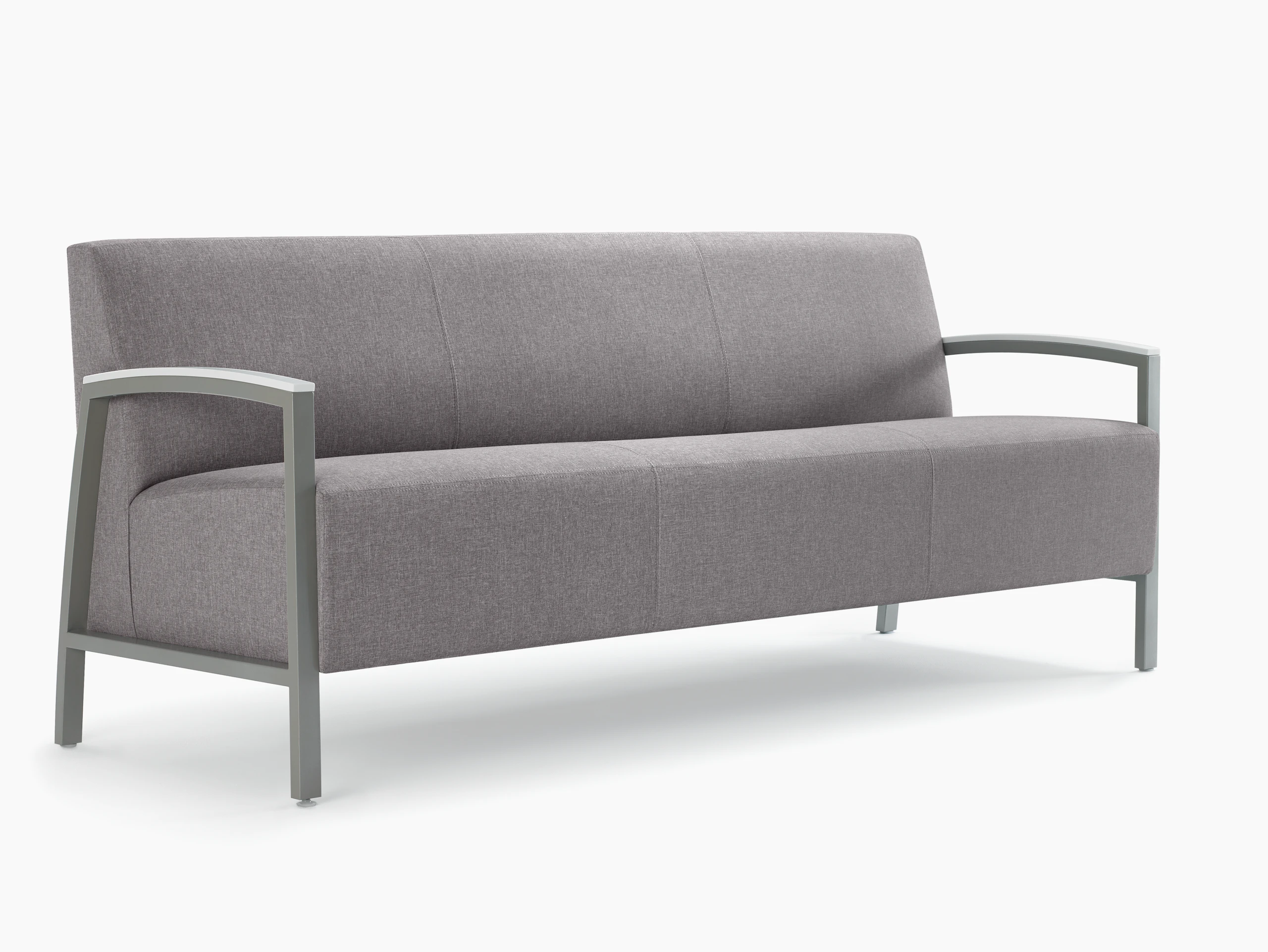 Front three-quarter view of a gray Brava Modern Lounge Seating sofa with solid surface arm caps.