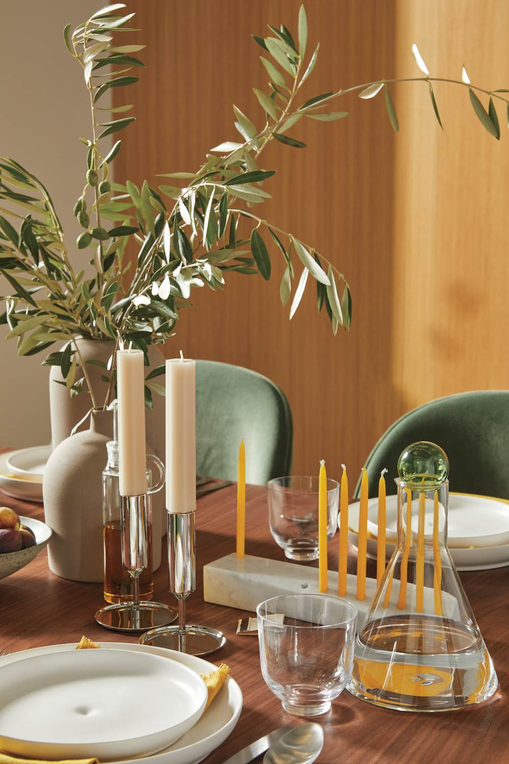 Bilboquet Carafe, Tunes Candleholders, and Ascalon Menorah Cross Extension Table with Eva Zeisel Granit Dinner Plate, and Ascalon Menorah on a dining room table 