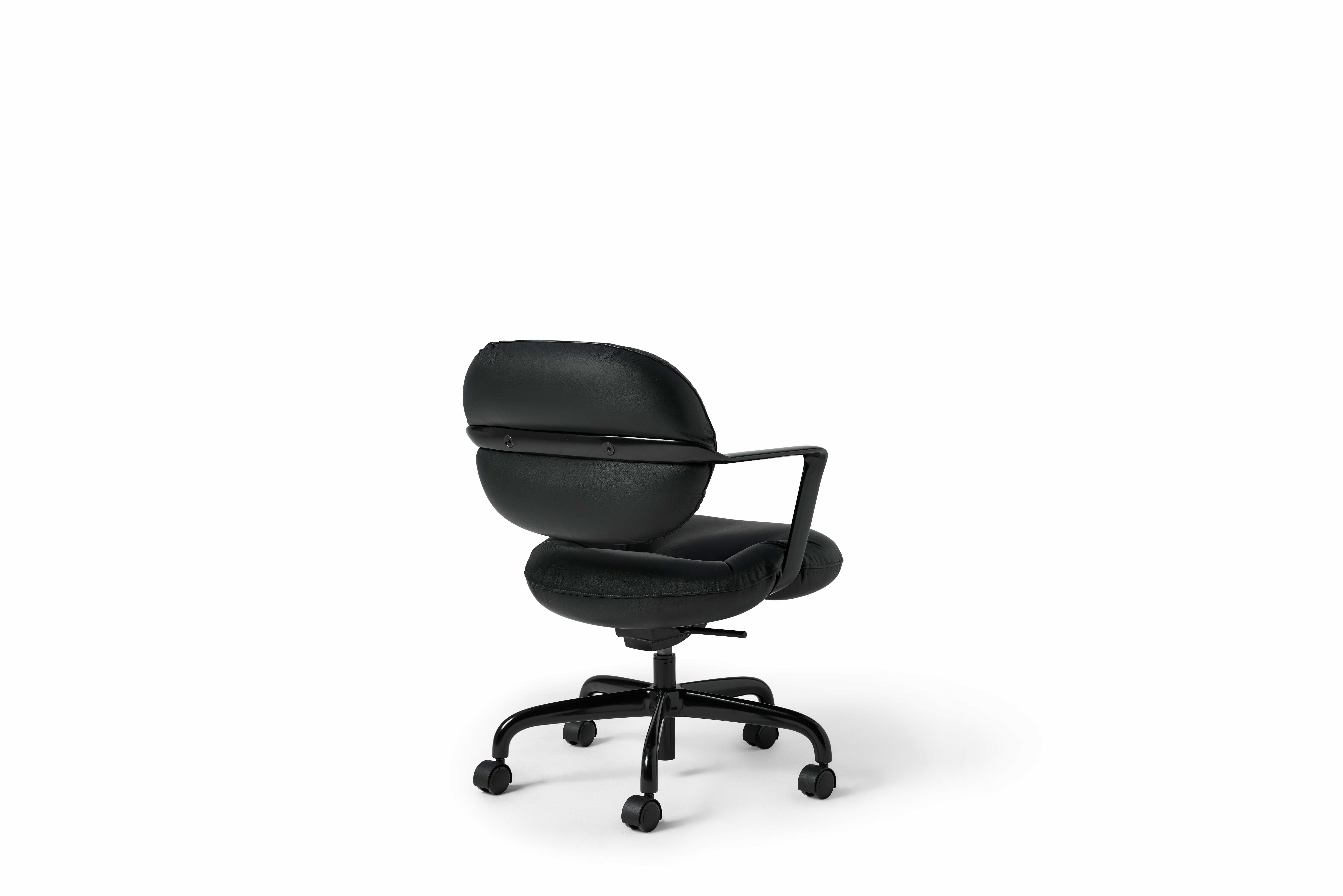 Rear angle view of a Morrison Hannah chair with a black frame and base with fixed arms and black leather upholstery.
