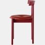 Profile view of a red Comma Chair with a seat pad.
