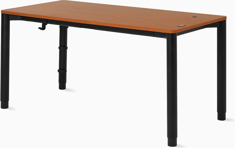 Angle view of a four leg height-adjustable table with a dark woodgrain surface and black base.