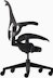 Black matte Aeron Chair on white background, with a 5-star base and ergonomic back support, viewed from the side.