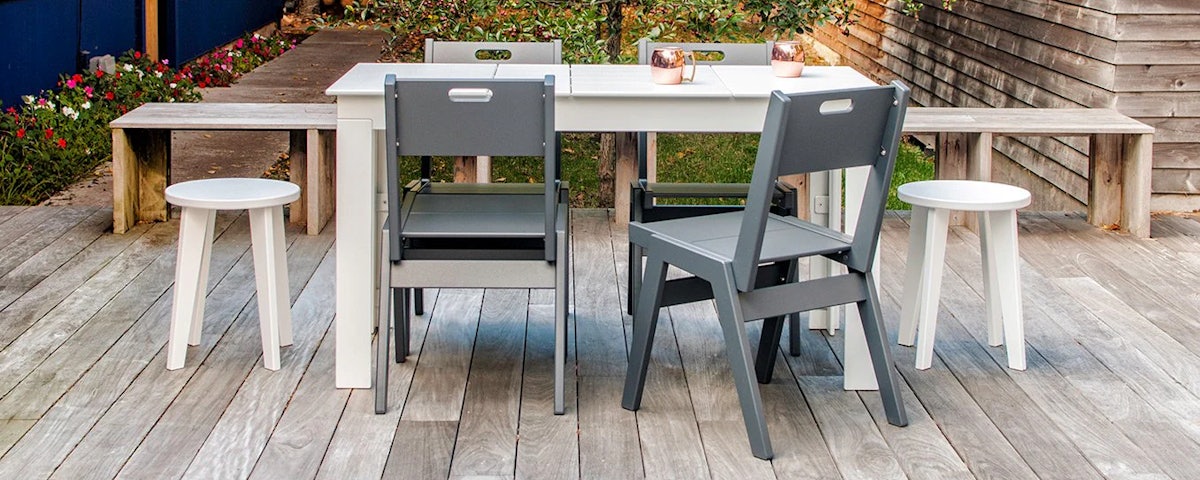 Alfresco Dining Chairs surrounding an Alfresco Dining Table on an outdoor wooden deck