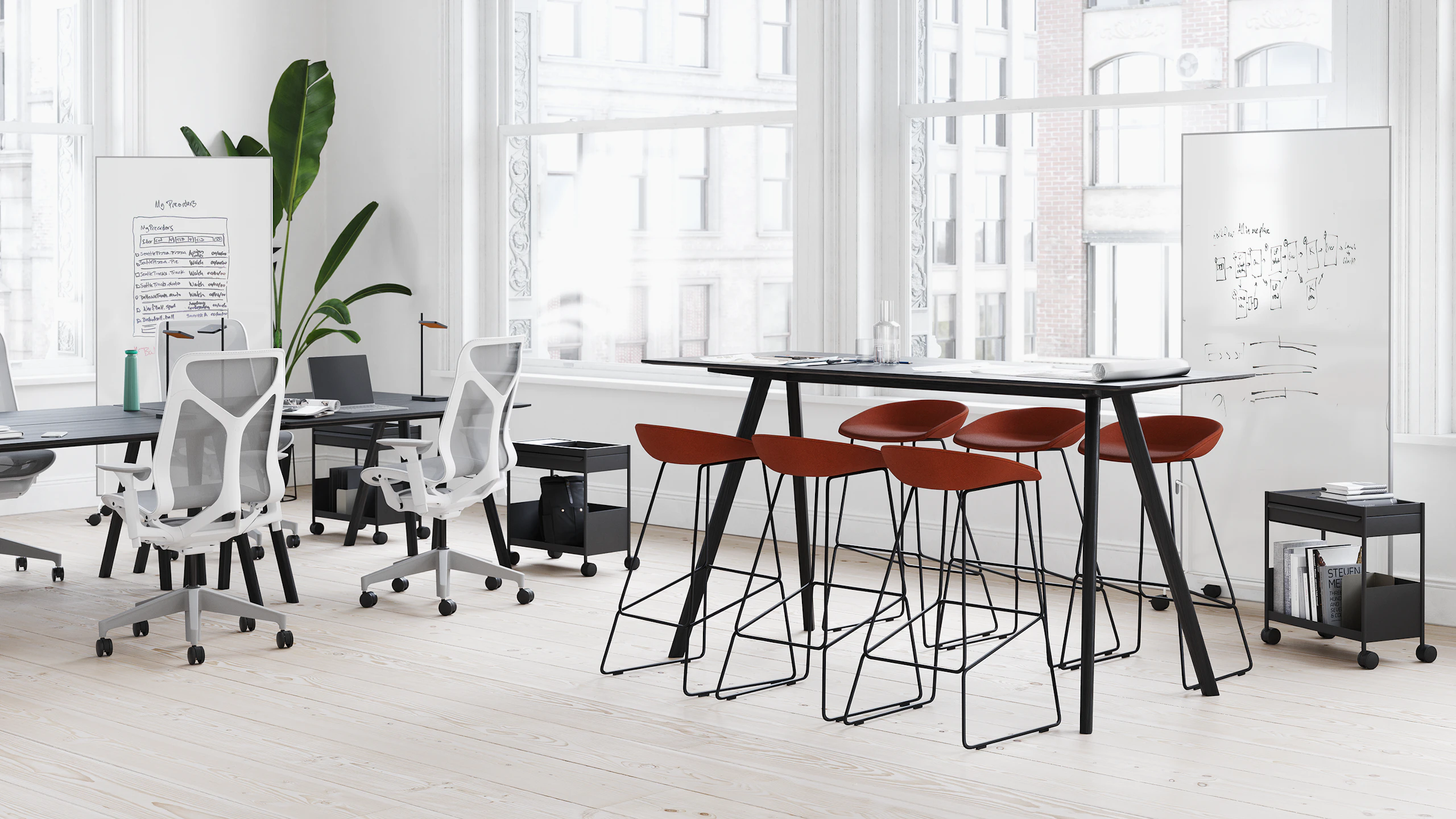 A small business office with one setting that supports individual work with HAY Copenhague Desks and Cosm Chairs and the other setting supporting collaborative work with HAY About A Stools around a Copenhague Table.