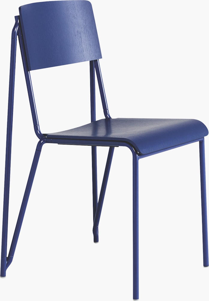A three quarter side view of a royal blue Petit Standard Chair.