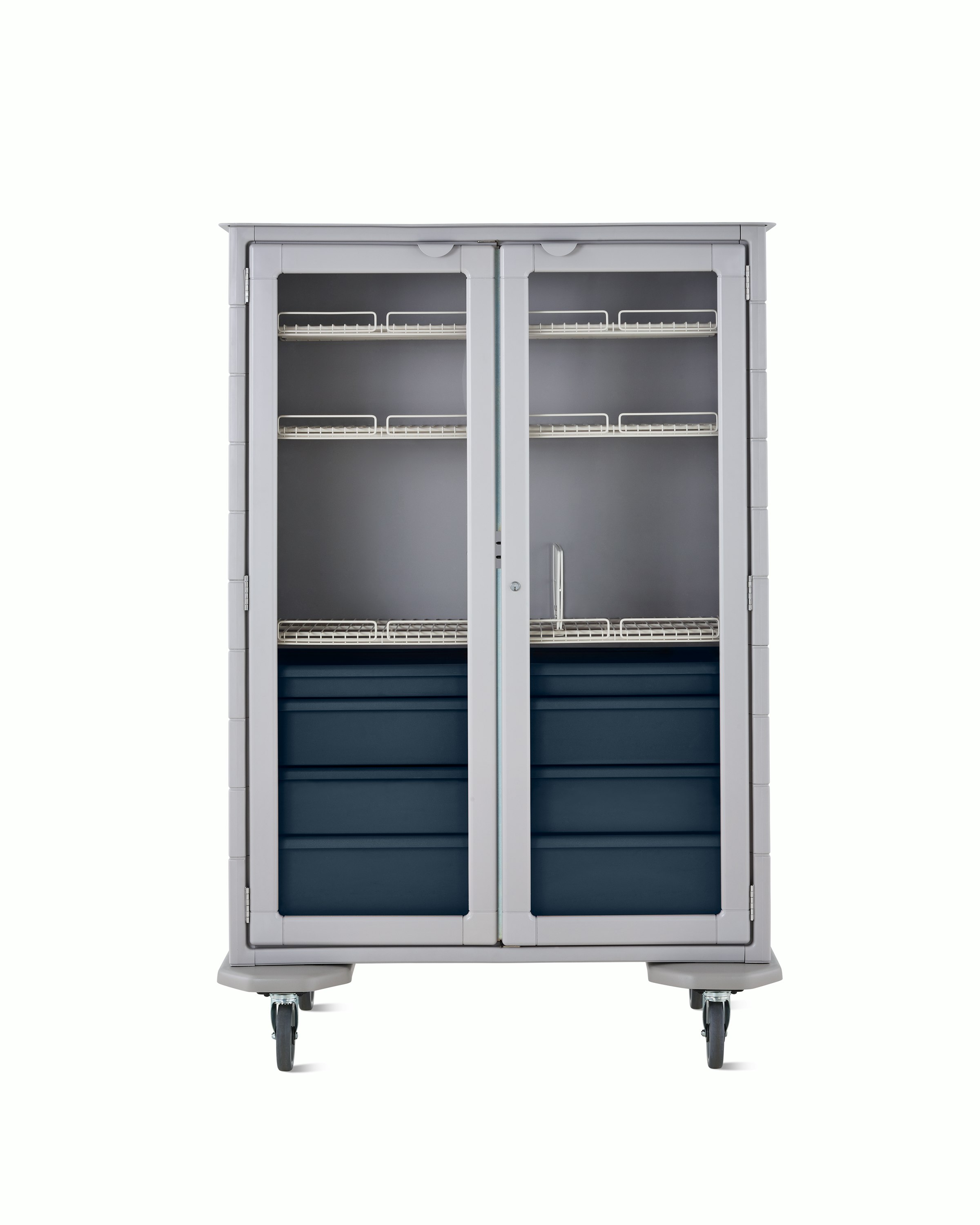 Front view of mobile double-wide supply cart with light gray body, dark blue drawers, wire shelves, and locking glass doors.