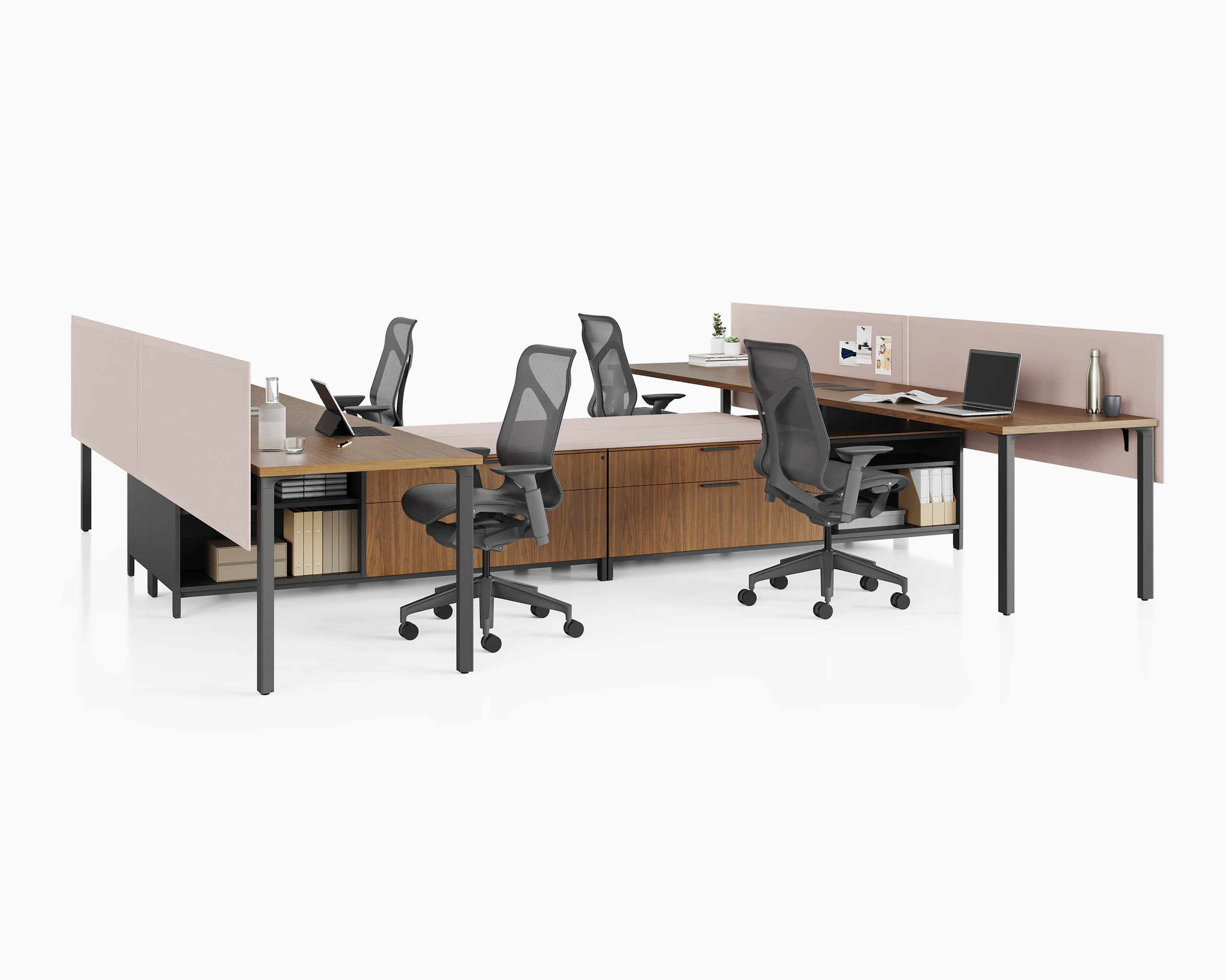 Group of four Canvas Storage workstations with wood surfaces, pink screens, and black Cosm Chairs.