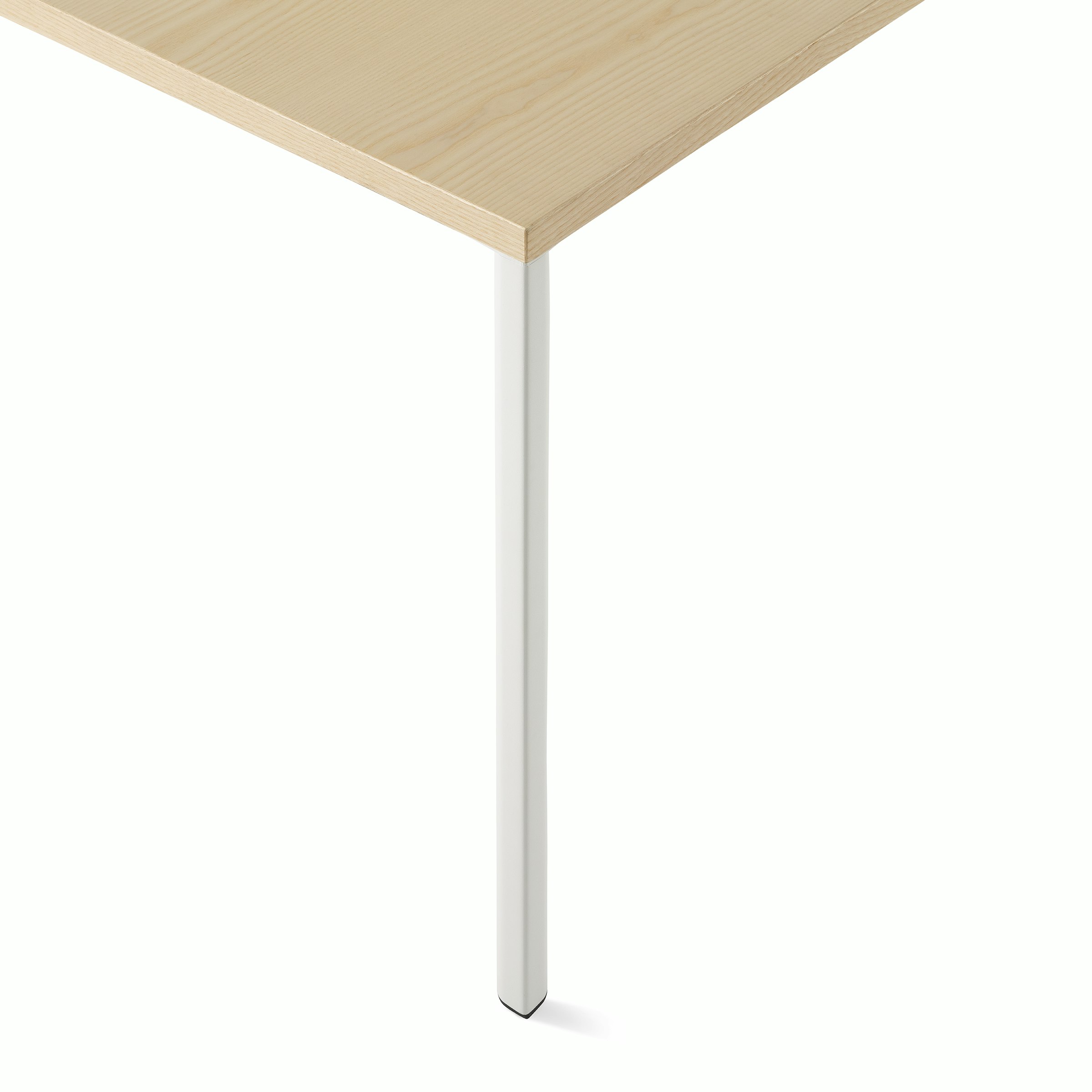 OE1 Rectangular Table with light brown surface and white leg viewed up close showing square edge leg detail.