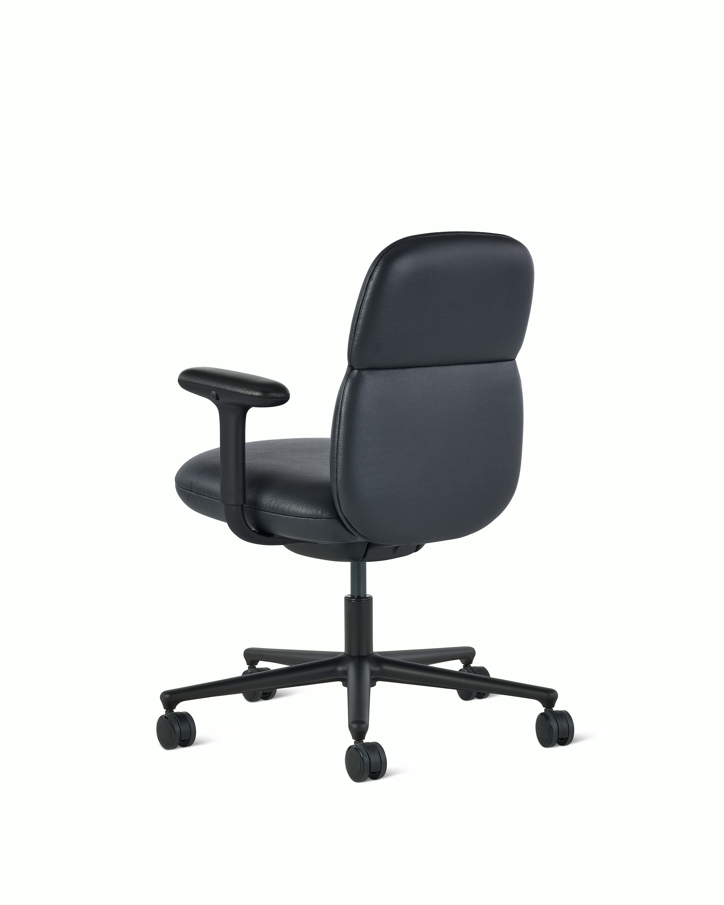 Rear angle view of a mid-back Asari chair by Herman Miller in black leather with height adjustable arms.