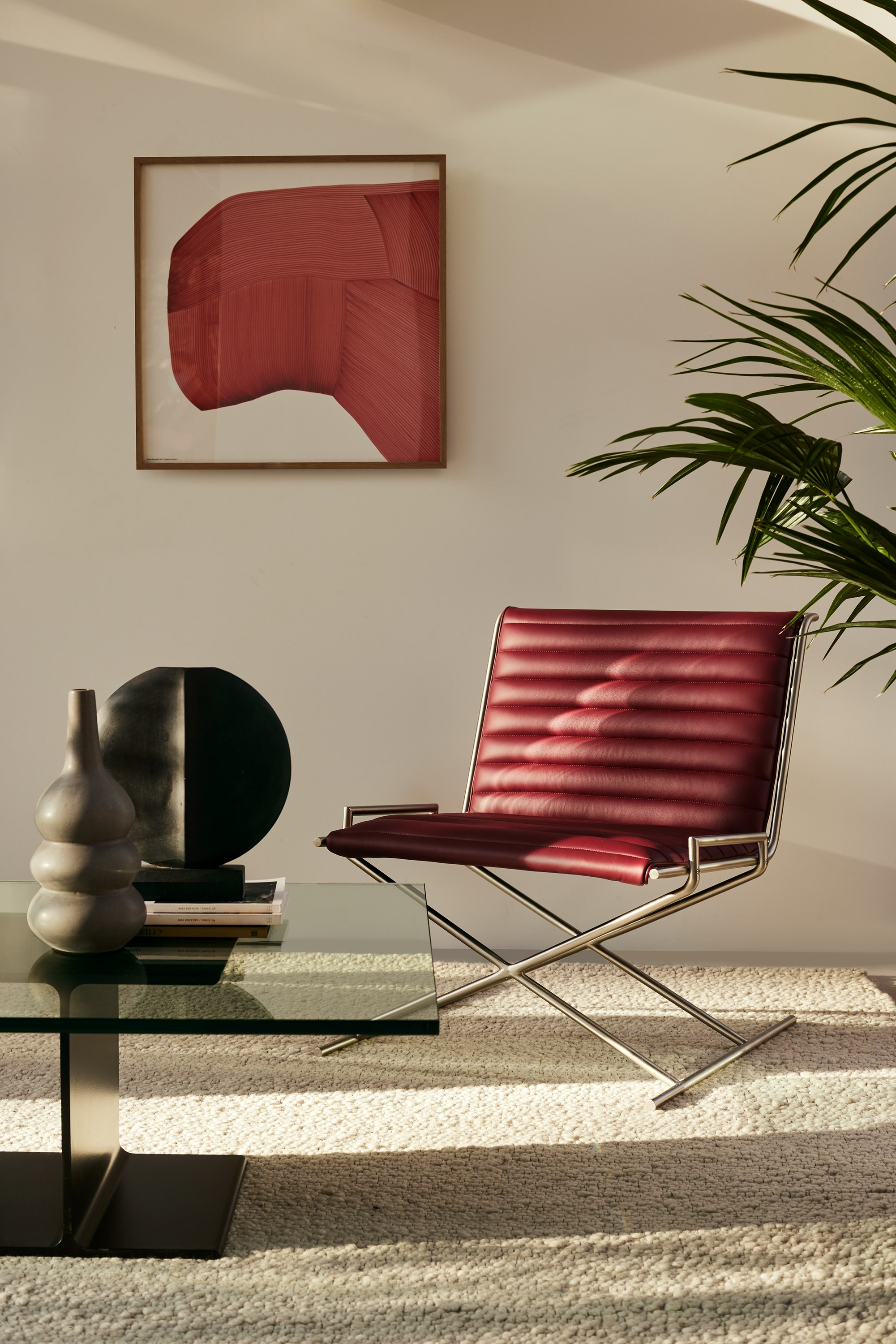 A Geiger seating area with Sled Base Chair and I Beam Coffee Table