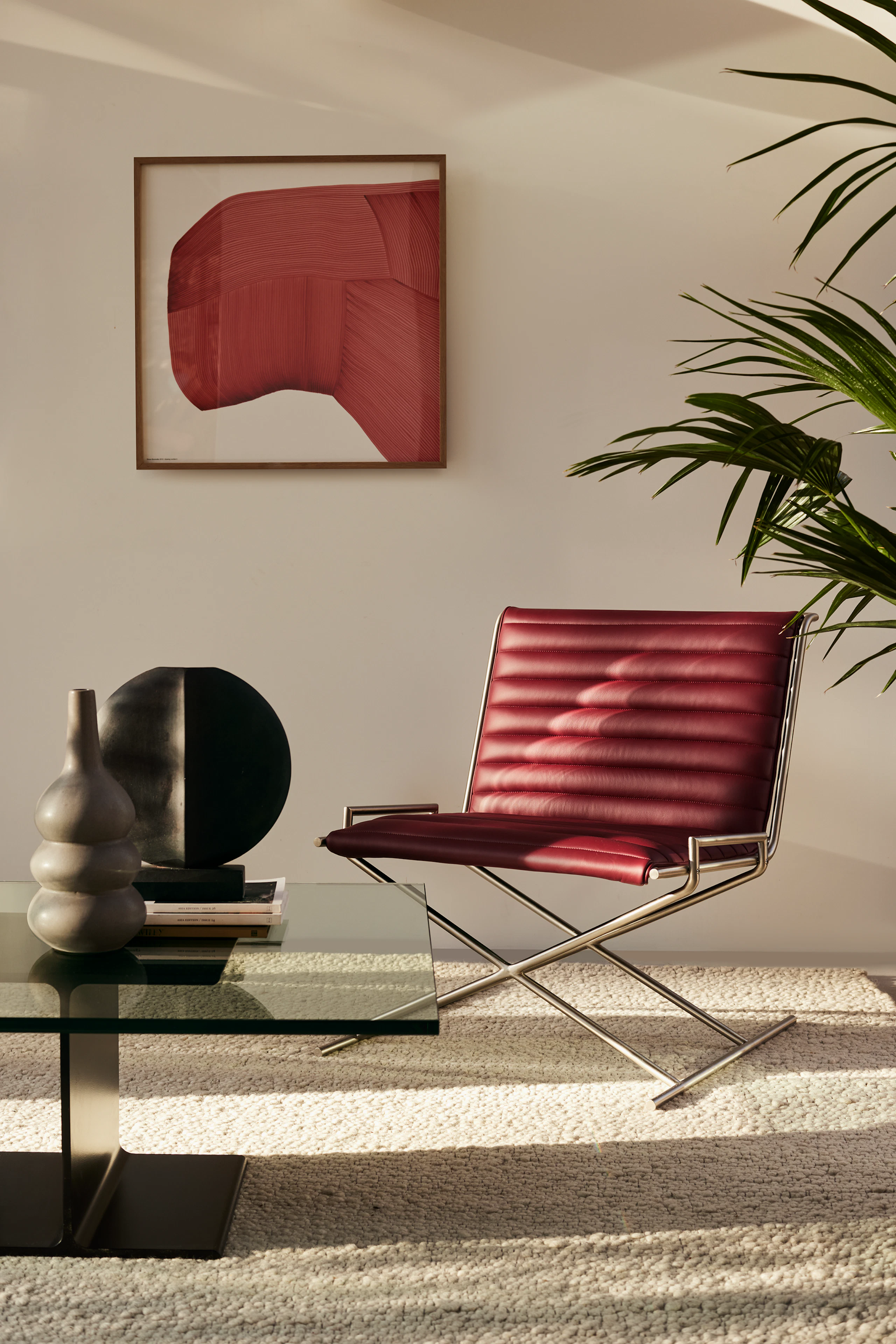 A Geiger seating area with Sled Base Chair and I Beam Coffee Table