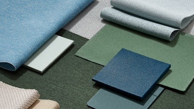 Multiple swatches of fabric in varying colours neatly folded.