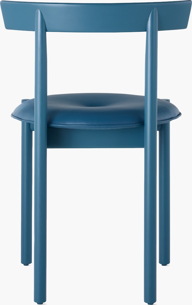 A blue Comma Chair with a seat pad, viewed from the back.
